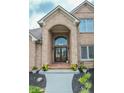 Welcoming front entrance featuring double doors, stylish brickwork, and beautiful potted plants at 7845 Centerstone Ct, Indianapolis, IN 46259