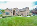 Attractive brick home with lush green lawn, tasteful landscaping, and inviting walkway at 7845 Centerstone Ct, Indianapolis, IN 46259