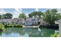 Backyard view of a home featuring a waterfront, serene environment with neighboring houses at 7846 Park North Cir, Indianapolis, IN 46260