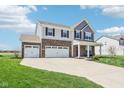 Attractive two-story home featuring a well-kept lawn, driveway, and three-car garage for ample parking at 9916 Gallop Ln, Fishers, IN 46040