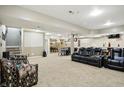 Spacious finished basement offering a recreational area with a bar, pool table and comfortable seating at 1013 Chapman Blvd, Greenfield, IN 46140
