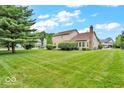 Spacious backyard with a lush lawn and mature trees, providing a private and serene setting at 11123 Garrick St, Fishers, IN 46038