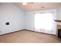 Bright living room with neutral carpet, a ceiling fan, fireplace and natural light streaming through the window at 126 Old Farm Rd, Danville, IN 46122