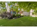 Landscaped front yard of a two story home, showing mature trees and green lawn at 13214 Dunwoody Ln, Carmel, IN 46033