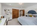 Bright bedroom featuring a soft blue bedspread, a large closet, and a view into the hall at 1393 Stoney Creek Cir, Carmel, IN 46032