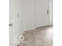 Bright entryway showcasing neutral-toned tile flooring and white doors at 1456 Willow Tree Ln, Sheridan, IN 46069