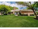 Lovely single-story brick house with a well-kept lawn and mature trees at 1540 Roanoke Dr, Zionsville, IN 46077