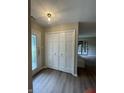Bright foyer with wood-look floors, double closet doors, and front door with decorative glass at 1540 Roanoke Dr, Zionsville, IN 46077