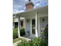 Inviting front entrance with stone accents, a covered porch, and beautiful landscaping with vibrant greenery at 1540 Roanoke Dr, Zionsville, IN 46077