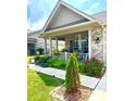 Charming home featuring a covered front porch with flower boxes and beautifully landscaped garden at 1688 Magnolia Dr, Greenwood, IN 46143