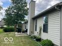 This home boasts an outdoor patio perfect for relaxing and entertaining with its lush green lawn at 17717 Cedarbrook Dr, Westfield, IN 46074