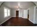 Bright and airy living room with hardwood floors, a ceiling fan, and archway into adjacent rooms at 2025 Fairview St, Anderson, IN 46016