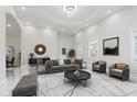 A sun-drenched living room boasts recessed lights, stylish furniture, and neutral tones at 2125 N Pasadena St, Indianapolis, IN 46219