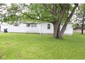 Exterior of a home featuring a well-maintained lawn, siding, and a shade tree at 220 S 2Nd St, Summitville, IN 46070