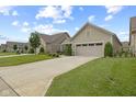 Manicured lawns lead to houses with two-car garages on a street with a sidewalk at 2246 Heather Glen Way, Franklin, IN 46131