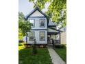 Charming two-story home features blue and grey siding, covered porch, well-kept landscaping at 2347 N Pennsylvania St, Indianapolis, IN 46205