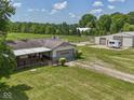 Aerial view of a home, garage, barn, pasture, and fencing on a sunny day at 2868 S 525 W, Trafalgar, IN 46181