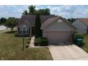 Aerial view of a well-maintained home featuring a two-car garage and mature landscaping at 291 Lakemoore St, Brownsburg, IN 46112