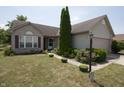 Inviting home with lush landscaping, a well-maintained lawn, and a cozy front porch at 291 Lakemoore St, Brownsburg, IN 46112