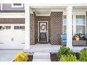 Inviting front porch with brick columns, stylish seating, and a welcoming wreath on the front door at 3969 Canning St, Danville, IN 46122