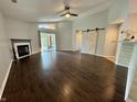 Bright living room featuring a cozy fireplace, wood floors, sliding glass door and a sliding barn door at 4049 Zinfandel Way, Indianapolis, IN 46254