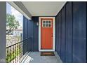 A close-up of a home's entry, showcasing a brightly painted door and stylish exterior lighting at 413 E Caven St, Indianapolis, IN 46225