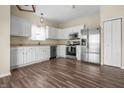 Bright kitchen featuring white cabinets, stainless steel appliances, and wood-look flooring at 452 Southern Pines Dr, Whiteland, IN 46184