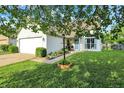 Well-manicured lawn and shrubbery surrounding the exterior of a charming single Gathering home at 5225 Thompson Park, Indianapolis, IN 46237