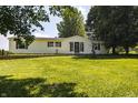 Well-maintained home with a brick foundation, complemented by a vibrant green lawn and mature trees at 5387 E County Road 800 S, Mooresville, IN 46158