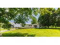Charming home with a lush green lawn and mature trees, creating a serene and inviting atmosphere at 5387 E County Road 800 S, Mooresville, IN 46158