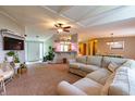 Inviting living room featuring a cozy sectional sofa, ceiling fan, and open layout to the kitchen and dining area at 5387 E County Road 800 S, Mooresville, IN 46158