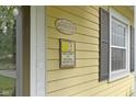 Welcome to Historic Irvington signage mounted on the home's yellow exterior at 5715 Oak Ave, Indianapolis, IN 46219