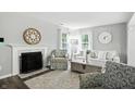 Cozy living room with a fireplace, comfortable seating, and lots of natural light at 6495 Titania Dr, Indianapolis, IN 46236