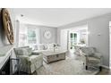 Bright living room with stylish furnishings, a fireplace, and seamless connection to dining area at 6495 Titania Dr, Indianapolis, IN 46236
