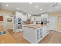 Bright kitchen with white cabinetry, stainless steel appliances, and a spacious center island at 6733 Jons, Zionsville, IN 46077