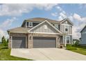 Beautiful two-story home showcasing a spacious driveway and attractive curb appeal on a sunny day at 6902 Diamondleaf Way, Brownsburg, IN 46112