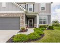 Inviting front porch featuring lush landscaping and a welcoming entrance to this lovely home at 6902 Diamondleaf Way, Brownsburg, IN 46112