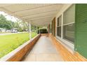 Covered front porch with brick base and view of the landscaped front yard at 814 N Noble St, Greenfield, IN 46140