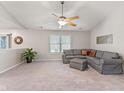 Spacious living room featuring carpet, a ceiling fan, and ample natural light at 834 Delray Dr, Indianapolis, IN 46241