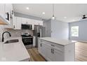 Bright kitchen features white cabinets, stainless steel appliances, a center island, and modern pendant lighting at 8355 Fieldfare Way, Indianapolis, IN 46237
