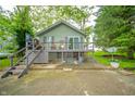 Charming home exterior with a rustic feel and stairs leading to a deck, offering cozy outdoor living at 8842 S Pleasure Valley Rd, Waldron, IN 46182
