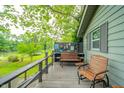 Cozy porch area furnished with chairs and bench, overlooking a serene river view at 8842 S Pleasure Valley Rd, Waldron, IN 46182