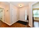 Bright foyer with hardwood floors and white doors, leading to other rooms in the house at 9022 Hosta Way, Camby, IN 46113