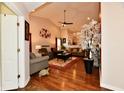 Inviting living room featuring vaulted ceilings, hardwood floors, and comfortable seating arrangements at 9022 Hosta Way, Camby, IN 46113