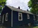 Image showcases the home's rear elevation with white trim around the windows at 94 N Routiers Ave, Indianapolis, IN 46219