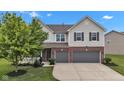 Beautiful exterior featuring a two-story home with a two-car garage and well-manicured lawn at 9724 Brooks Dr, Fishers, IN 46055