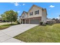 Attractive two-story home with a spacious driveway, attached two-car garage, and lush green lawn at 9724 Brooks Dr, Fishers, IN 46055