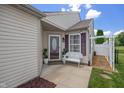 Inviting front porch with a white bench and beautifully landscaped garden at 10758 Cyrus Dr, Indianapolis, IN 46231