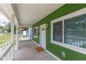 Covered front porch features durable flooring, fresh paint, updated lighting, and a street view at 1122 W 35Th St, Indianapolis, IN 46208