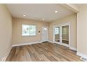 This living room features updated flooring, recessed lights, fresh paint and a view of the front porch at 1122 W 35Th St, Indianapolis, IN 46208